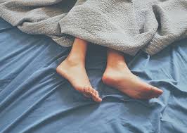 closeup shot of feet of a person on the bed
